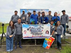 Group of people posing with a banner for the "2025 International Coastal Clean-Up" event in Bacoor City.