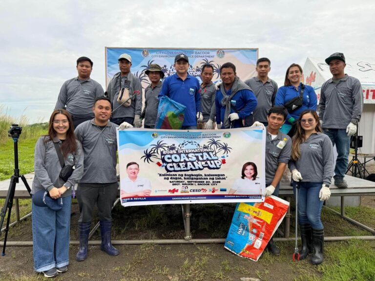 Group of people posing with a banner for the "2025 International Coastal Clean-Up" event in Bacoor City.